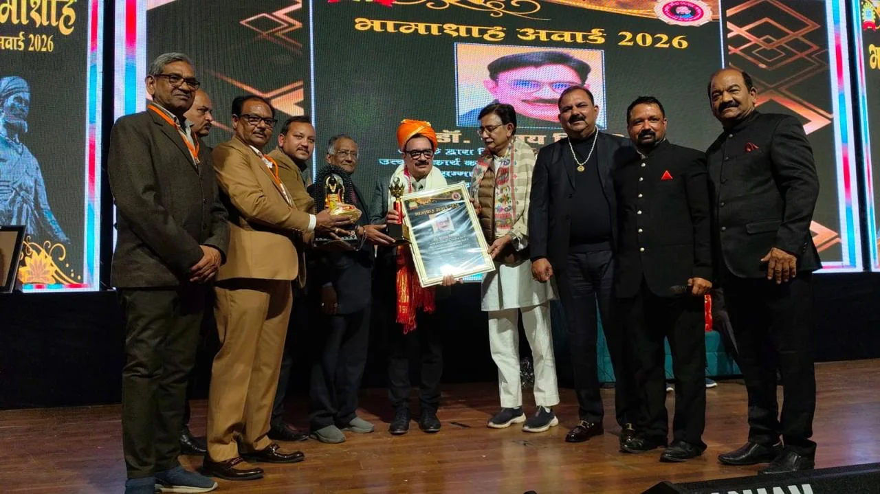 Bhamashah Award 2026 winner holding trophy and certificate during felicitation ceremony with traditional shawl